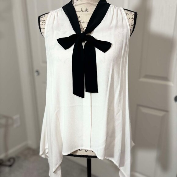 Elle Tops - White Sleeveless Top with a Black Accented Bow with Pointed Hips & Pleated Neck